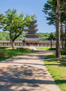 Buyeo, South Korea, July 7, 2018: Sidewalk leading to main gate of Neungsa Baekje Temple with five