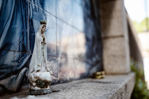 Holy Mary statue with the religious background made of Portuguese traditional tiles, Porto,