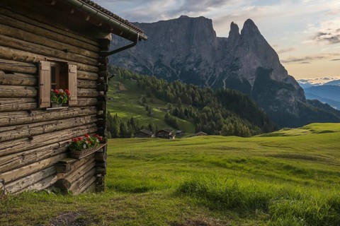 Alpine hut on the Alpe di Siusi, behind the peak of the Sciliar, Val Gardena, Dolomites, South