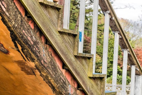 Closeup of wooden outdoor staircase on old abandoned building