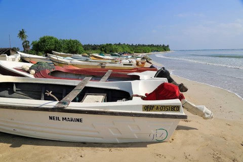 Boats and fishing canoes tropical beach at Pasikudah Bay, Eastern Province, Sri Lanka, Asia