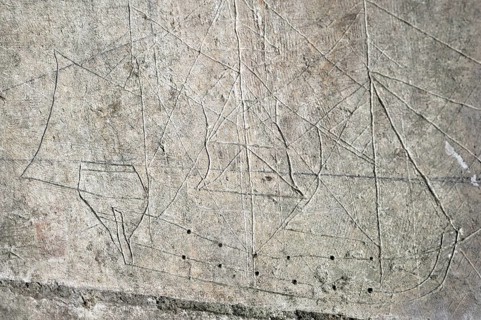 Old graffiti of galleon sailing ship carved on rampart wall of the citadel at Brouage,
