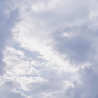 Cloudy sky background with sunlight shining through white clouds. Natural backdrop