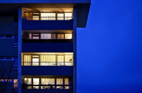 Illuminated flats in a tower block in Gropiusstadt. The rise in rents in German cities has