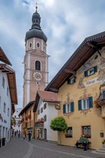 Alley in Castelrotto with the parish church of St Peter and Paul, Castelrotto, South Tyrol, Italy,