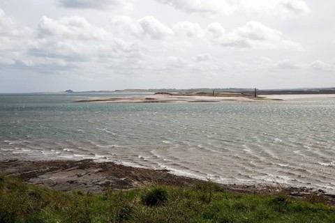 Narrow coastal channel between mainland and Holy Island, Lindisfarne, Northumberland, England, UK