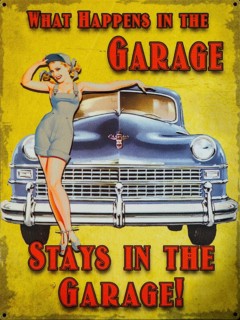 Old enamel sign 'What happens in the garage stays in the garage' woman posing by car