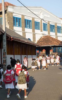 School girls in uniform walking in a street in the historic town of Galle, Sri Lanka, Asia