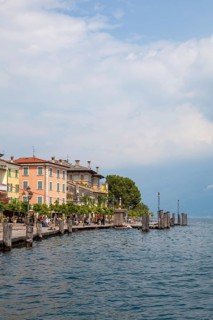 Waterfront promenade with restaurants in Gargnano, Lake Garda, Province of Brescia, Lombardy,
