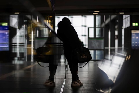 A person stands waiting at Berlin Central Station. Today is the second day of the strike by the