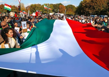 Iranians demonstrate in Berlin with a large Iranian flag to support the protests in Iran. The