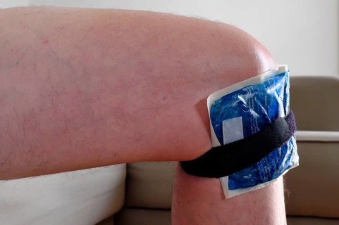 Swollen knee with cold pack, after a slip, Munich, Bavaria, Germany, Europe