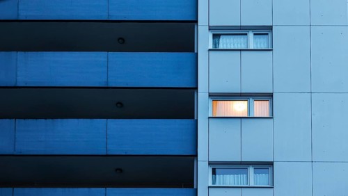 Illuminated room in a tower block in Gropiusstadt. The rise in rents in German cities has increased