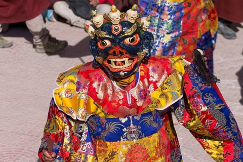 A monk performing cham, the sacred religious masked dance, during the Spituk Gustor winter festival