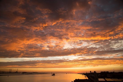 Sunset orange glow landscape clouds water, North Sea shipping, Port of Rotterdam, Hook of Holland,