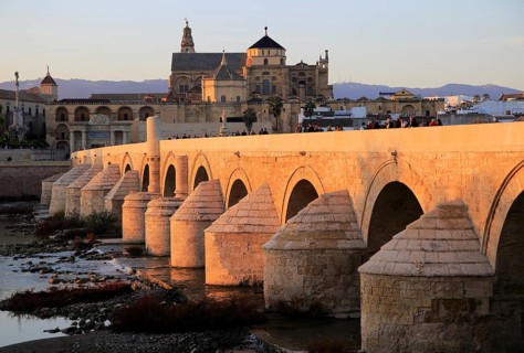 Roman bridge spanning river Rio Guadalquivir with Mezquita buildings, Cordoba, Spain, Europe