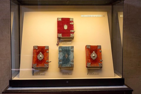 Glass display case of historic bible books inside the cathedral, former Great mosque, Cordoba,