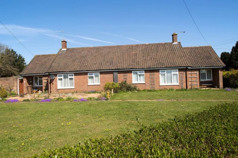 Semi-detached bungalow housing in village of Sutton, Suffolk, England, UK