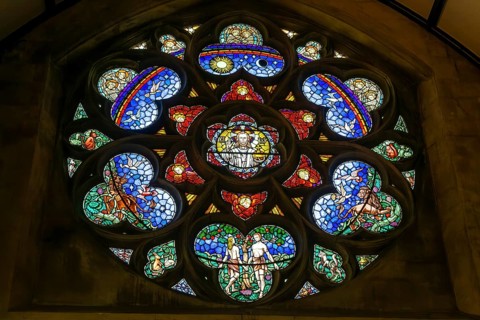 Stained glass window of Adam and Eve in Paradise, Roman catholic church of Saint John the