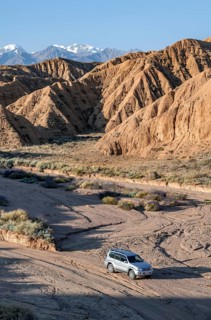 Off-road vehicle on off-road road, eroded hilly landscape, Badlands, Valley of the Forgotten
