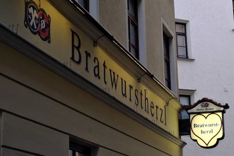 Illuminated sign of the traditional restaurant Bratwurstherzl at Viktualienmarkt, Munich, Bavaria,