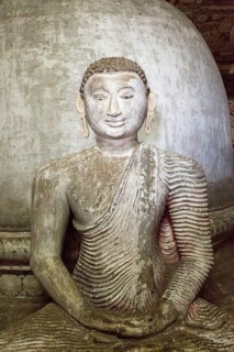 Buddha figure inside Dambulla cave Buddhist temple complex, Sri Lanka, Asia