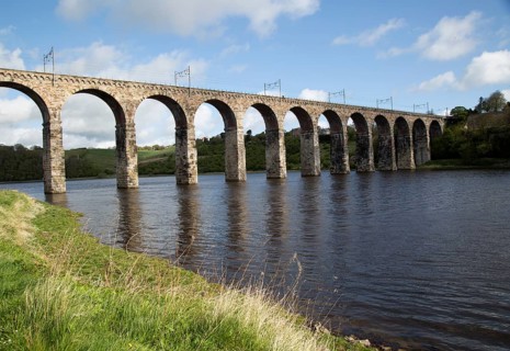 Stone arches of railway viaduct crossing River Tweed, Berwick-upon-Tweed, Northumberland, England,