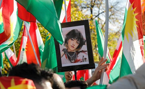 A picture of Mahsa Amini is shown at a demonstration in Berlin. Thousands of Iranians protest in