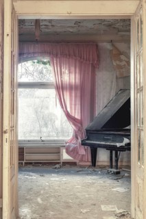 A damaged grand piano in a dilapidated room with tattered pink curtains and dust, urologist's villa