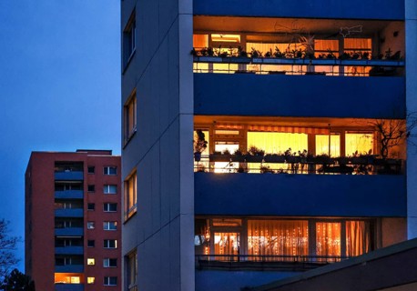Illuminated flats in high-rise buildings in Gropiusstadt. The rise in rents in German cities has