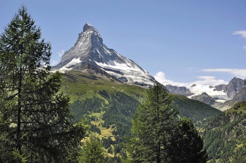 View over the Matterhorn mountain with alpine meadows and pine forests in the Swiss Alps, Valais,