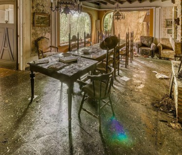 Sunlight dances on the table of an abandoned, dust-covered dining room, Maison Limmi, Lost Place,