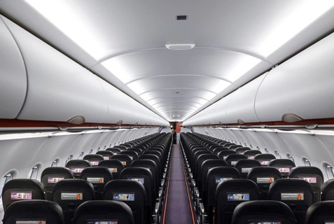 View into an empty aircraft compartment of an easyJet Airbus A320 neo in the newly opened easyJet