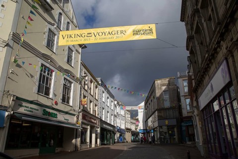 Threatening grey rain clouds over town centre street, Falmouth, Cornwall, England Viking Voyagers