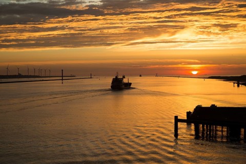 Sunset orange glow landscape clouds water, North Sea shipping, Port of Rotterdam, Hook of Holland,
