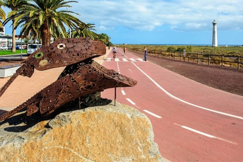 Sculpture made of scrap metal of marine animals two stingrays rays in the left foreground, in the
