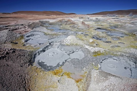 Mud lakes and steam pools with boiling mud in geothermal field Sol de Manana, Altiplano, Bolivia,