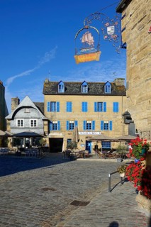 Rue du General de Gaulle in the old town centre of Le Faou with slate-roofed granite houses from
