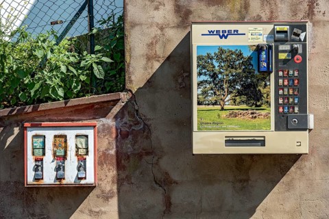 Chewing gum vending machine and cigarette vending machine together on a wall, vending machines for