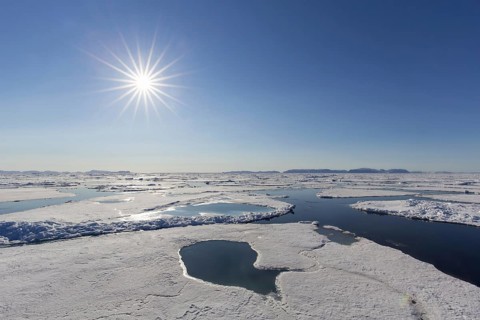 Midnight sun over the Arctic Ocean with drifting ice floes, north of the Arctic Circle at