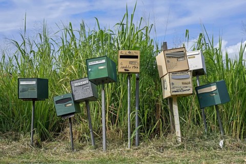 Row of individual mail boxes, letter boxes, mailboxes, letterboxes, postboxes of residents on the