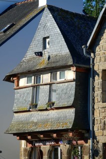 Rue du General de Gaulle in the old town centre of Le Faou with slate-roofed granite houses from