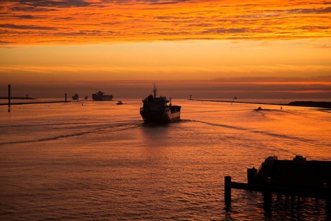 Sunset orange glow landscape clouds water, North Sea shipping, Port of Rotterdam, Hook of Holland,