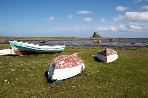 Castle and boats at low tide, Holy Island, Lindisfarne, Northumberland, England, UK