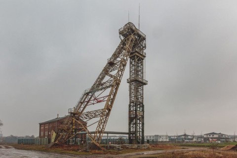 An old metal winding tower under a cloudy sky, a sign of the industrial past, Lost Place,