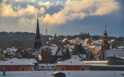 Golden sunlight over a snow-covered town with protruding church towers, Wuppertal Vohwinkel, North
