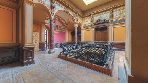 Elegant foyer with wrought-iron railings, columns and arches, luxurious interior design, Villa