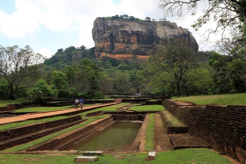 Tourists walking in the palace water gardens, Sigiriya Rock palace, Central Province, Sri Lanka,