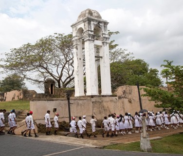School children in uniform walking in a street in the historic town of Galle, Sri Lanka, Asia