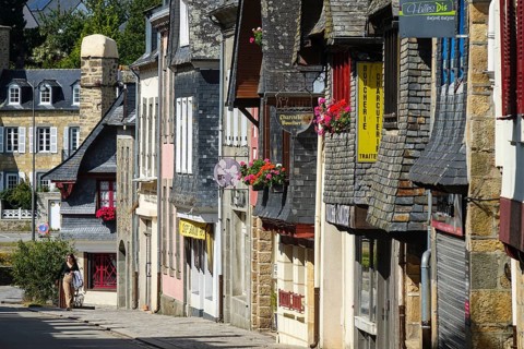 Rue du General de Gaulle in the old town centre of Le Faou with slate-roofed granite houses from